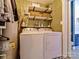 Well-lit laundry room with updated washer/dryer, shelving, and decor at 3300 Selwyn Farms Ln # 5, Charlotte, NC 28209