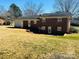 Backyard view of a brick home featuring a well-maintained lawn at 344 Circleview Dr, Shelby, NC 28150
