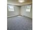 Bedroom features gray walls, gray carpet, white trim, and two windows letting in plenty of natural light at 344 Circleview Dr, Shelby, NC 28150