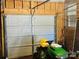This garage features a white door and a yard tractor to keep your yard nicely maintained at 344 Circleview Dr, Shelby, NC 28150