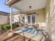 Covered porch with outdoor seating with a decorative blue and white rug at 3465 Caldwell Ridge Pkwy, Charlotte, NC 28213