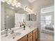 Bathroom boasts double sink vanity with a view into the Primary bedroom at 3465 Caldwell Ridge Pkwy, Charlotte, NC 28213