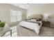 Serene bedroom offers lots of natural light and neutral decor for a relaxing retreat at 3465 Caldwell Ridge Pkwy, Charlotte, NC 28213