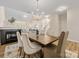 Formal dining room with elegant chandelier flowing into an open living room at 3465 Caldwell Ridge Pkwy, Charlotte, NC 28213