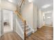 Hallway and staircase with wood and carpet floors and a glimpse into an adjacent room at 3465 Caldwell Ridge Pkwy, Charlotte, NC 28213