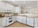 Clean kitchen with modern appliances, white cabinets and ceramic tile flooring at 3465 Caldwell Ridge Pkwy, Charlotte, NC 28213