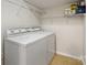 Bright laundry area featuring a white washer and dryer, as well as wire shelving at 3465 Caldwell Ridge Pkwy, Charlotte, NC 28213