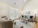 Bright living room boasts high ceilings, neutral tones, and access to outdoor space at 3465 Caldwell Ridge Pkwy, Charlotte, NC 28213