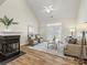 Bright living room featuring a cozy fireplace, ample seating, and natural light at 3465 Caldwell Ridge Pkwy, Charlotte, NC 28213