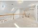 Spacious loft area with skylights, carpet flooring, and wood railing overlooking the lower level at 3465 Caldwell Ridge Pkwy, Charlotte, NC 28213
