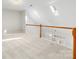 An airy loft space with natural light, carpet, and wooden railing at 3465 Caldwell Ridge Pkwy, Charlotte, NC 28213
