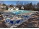 Community pool with seating, surrounded by trees in a fenced-in area at 3465 Caldwell Ridge Pkwy, Charlotte, NC 28213