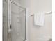 Bright bathroom featuring a glass enclosed shower with tiled walls, and a towel bar with a white towel at 3465 Caldwell Ridge Pkwy, Charlotte, NC 28213