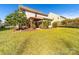 Spacious backyard with a covered patio, lush green grass, and mature trees at 3628 Benseval Ln, Matthews, NC 28104