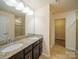 Bathroom with double vanity, granite countertop, and a separate shower stall at 3628 Benseval Ln, Matthews, NC 28104
