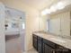 Bathroom featuring a double vanity with granite countertop and modern lighting at 3628 Benseval Ln, Matthews, NC 28104