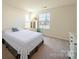 Bedroom with white bed linens and large window offering natural light at 3628 Benseval Ln, Matthews, NC 28104