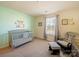 Bedroom bedroom with a grey crib, comfortable chair, and serene decor at 3628 Benseval Ln, Matthews, NC 28104