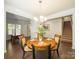 Formal dining room with a chandelier, table setting, and views of the staircase and office space at 3628 Benseval Ln, Matthews, NC 28104