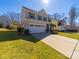 Inviting two-story home with well-kept lawn and a long drive leading to a two-car attached garage at 3628 Benseval Ln, Matthews, NC 28104