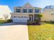 Charming two-story home featuring a two-car garage, well-maintained lawn and complementary landscaping at 3628 Benseval Ln, Matthews, NC 28104