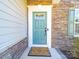 Close-up of the front door with decorative stone accents and a welcoming entrance mat at 3628 Benseval Ln, Matthews, NC 28104