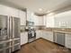 Well-equipped kitchen featuring stainless steel appliances, granite countertops, and white cabinetry at 3628 Benseval Ln, Matthews, NC 28104