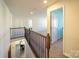 Upstairs landing offering a view of the dining area and access to various rooms at 3628 Benseval Ln, Matthews, NC 28104