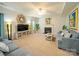 Comfortable living room with a ceiling fan, fireplace, neutral-toned furniture, and decorative accents at 3628 Benseval Ln, Matthews, NC 28104