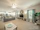 Spacious living room with a ceiling fan, large windows, stylish decor, and an open view to the kitchen at 3628 Benseval Ln, Matthews, NC 28104