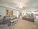 Large open-concept living room featuring two sofas, a staircase, and seamless access to the modern kitchen at 3628 Benseval Ln, Matthews, NC 28104