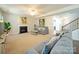 Inviting living area with a fireplace, neutral carpeting, staircase, and access to other rooms at 3628 Benseval Ln, Matthews, NC 28104