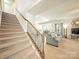 Open staircase leading into the living room with a view of the kitchen and comfortable seating area at 3628 Benseval Ln, Matthews, NC 28104