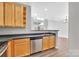 Well-lit kitchen area with wooden cabinets and stainless steel dishwasher at 3655 Warp St, Charlotte, NC 28205