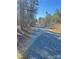 A long gravel driveway leading through a wooded area, providing privacy and seclusion at 37254 Barnhardt Rd, New London, NC 28127