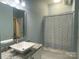 Bathroom featuring a vessel sink on a granite countertop and tub with blue patterned shower curtain at 404 N Laurel Ave # 28, Charlotte, NC 28204
