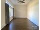 Bedroom featuring hardwood floors, neutral walls, a ceiling fan and a large window with curtains at 404 N Laurel Ave # 28, Charlotte, NC 28204