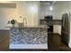 Modern kitchen with stainless appliances and stylish mosaic tile backsplash and island at 404 N Laurel Ave # 28, Charlotte, NC 28204