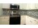 Well-lit kitchen featuring stainless steel appliances, granite counters, and stylish backsplash at 404 N Laurel Ave # 28, Charlotte, NC 28204