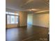 Spacious living room with hardwood floors and large windows with curtains for natural light at 404 N Laurel Ave # 28, Charlotte, NC 28204