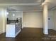 Open-concept living room with hardwood floors, an island with granite counters, and a modern kitchen at 404 N Laurel Ave # 28, Charlotte, NC 28204