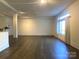 Large living room with hardwood floors, exposed duct work, and natural light from large windows at 404 N Laurel Ave # 28, Charlotte, NC 28204