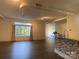 Living room with hardwood floors, industrial duct work, and large windows with curtains at 404 N Laurel Ave # 28, Charlotte, NC 28204