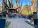 Outdoor patio with brick pavers, dining table, and seating area at 404 N Laurel Ave # 28, Charlotte, NC 28204