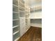 Spacious walk-in closet with custom shelving and storage solutions for optimal organization at 404 N Laurel Ave # 28, Charlotte, NC 28204