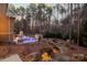 View of a backyard with a pool, patio, and surrounding trees from the rear of the house at 4893 River Hills Dr, Denver, NC 28037