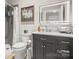 Modern bathroom featuring a sleek vanity, LED mirror, and tiled shower at 4893 River Hills Dr, Denver, NC 28037