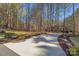 Long driveway leading to a traditional home with a well-manicured lawn and mature trees at 4893 River Hills Dr, Denver, NC 28037