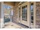Charming exterior entryway of a stone home with a decorative arched glass front door at 4893 River Hills Dr, Denver, NC 28037