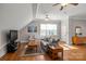 Cozy living room with hardwood floors, gray sofa, and bright window at 4893 River Hills Dr, Denver, NC 28037
